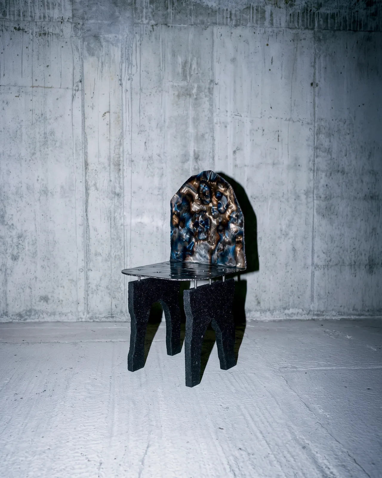 Ustio Chair against a concrete wall, by Paul Hardy