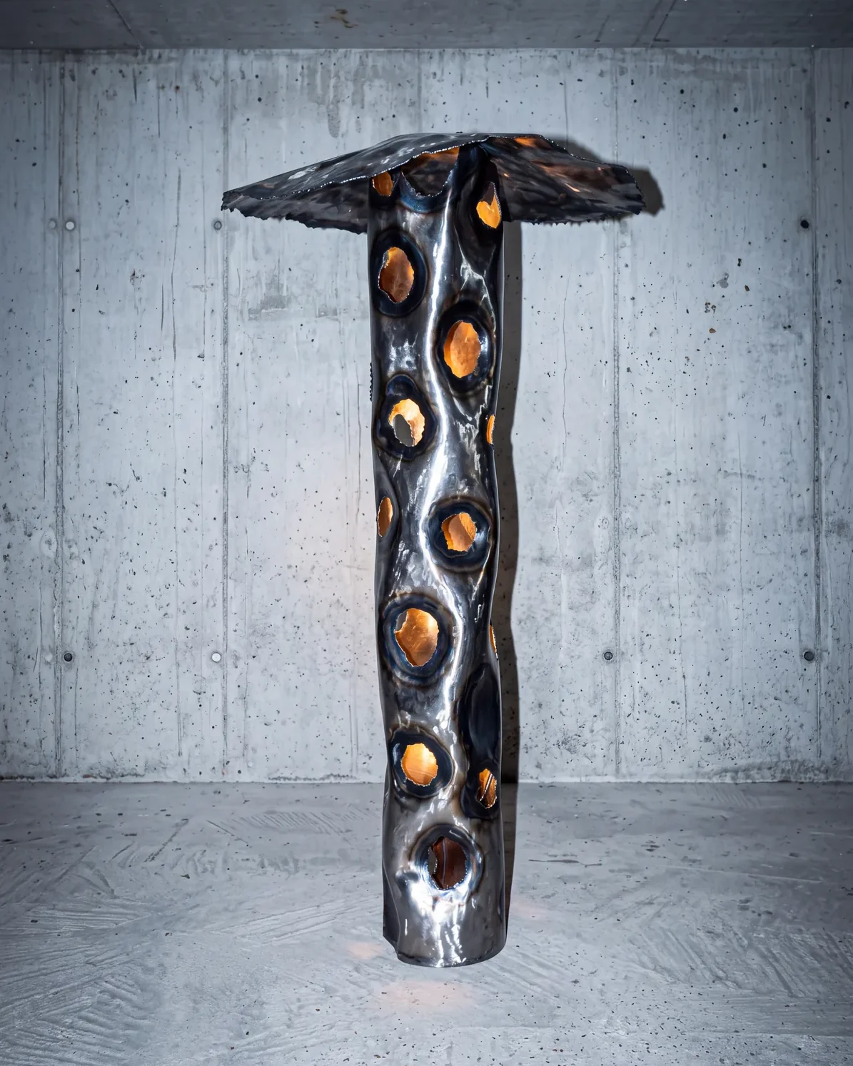 Ustio Lamp, lit, in a concrete room, by Paul Hardy