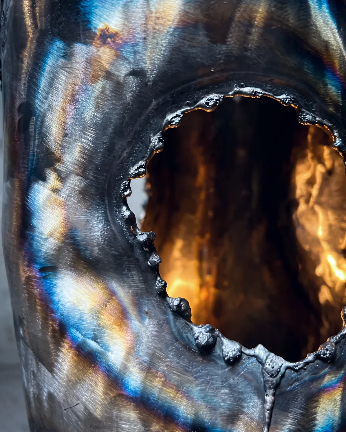Plasma-cut opening with heat tint, Ustio Lamp, by Paul Hardy