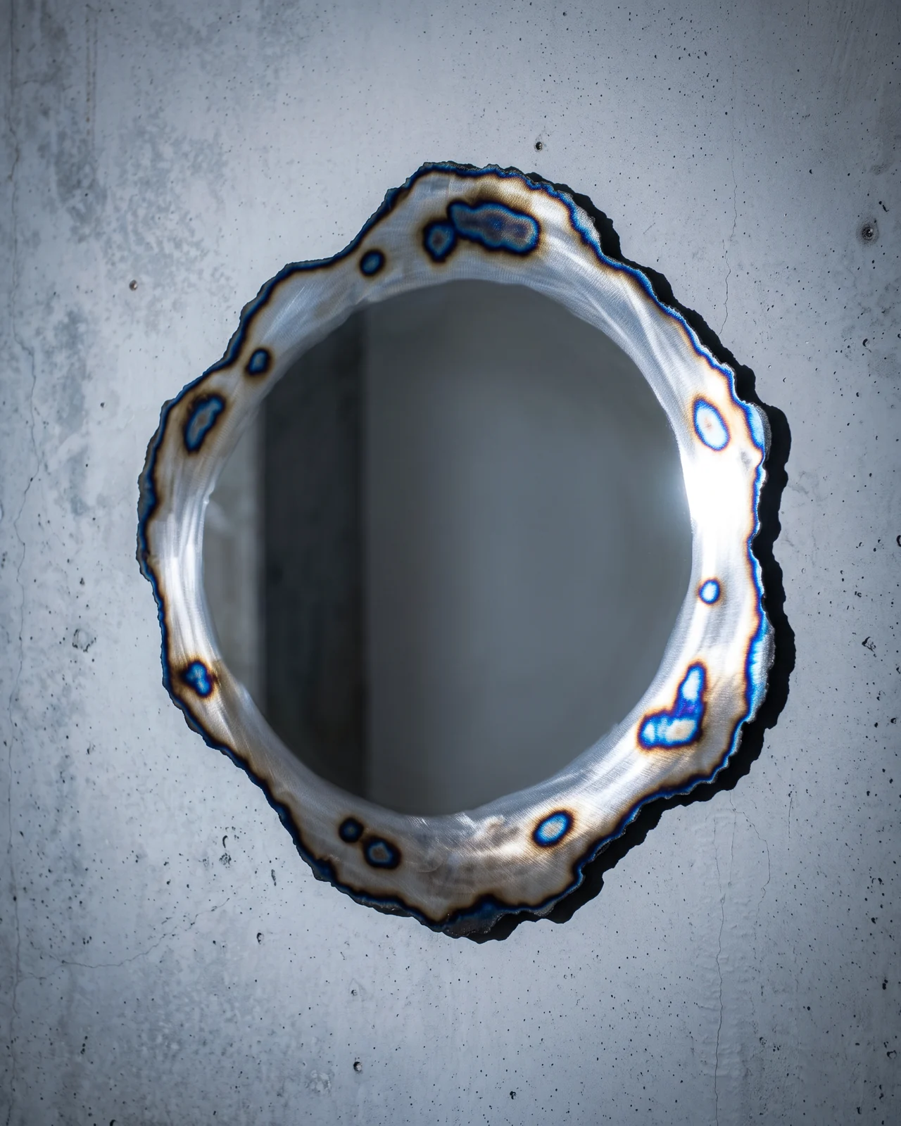Ustio Mirror on a concrete wall, by Paul Hardy