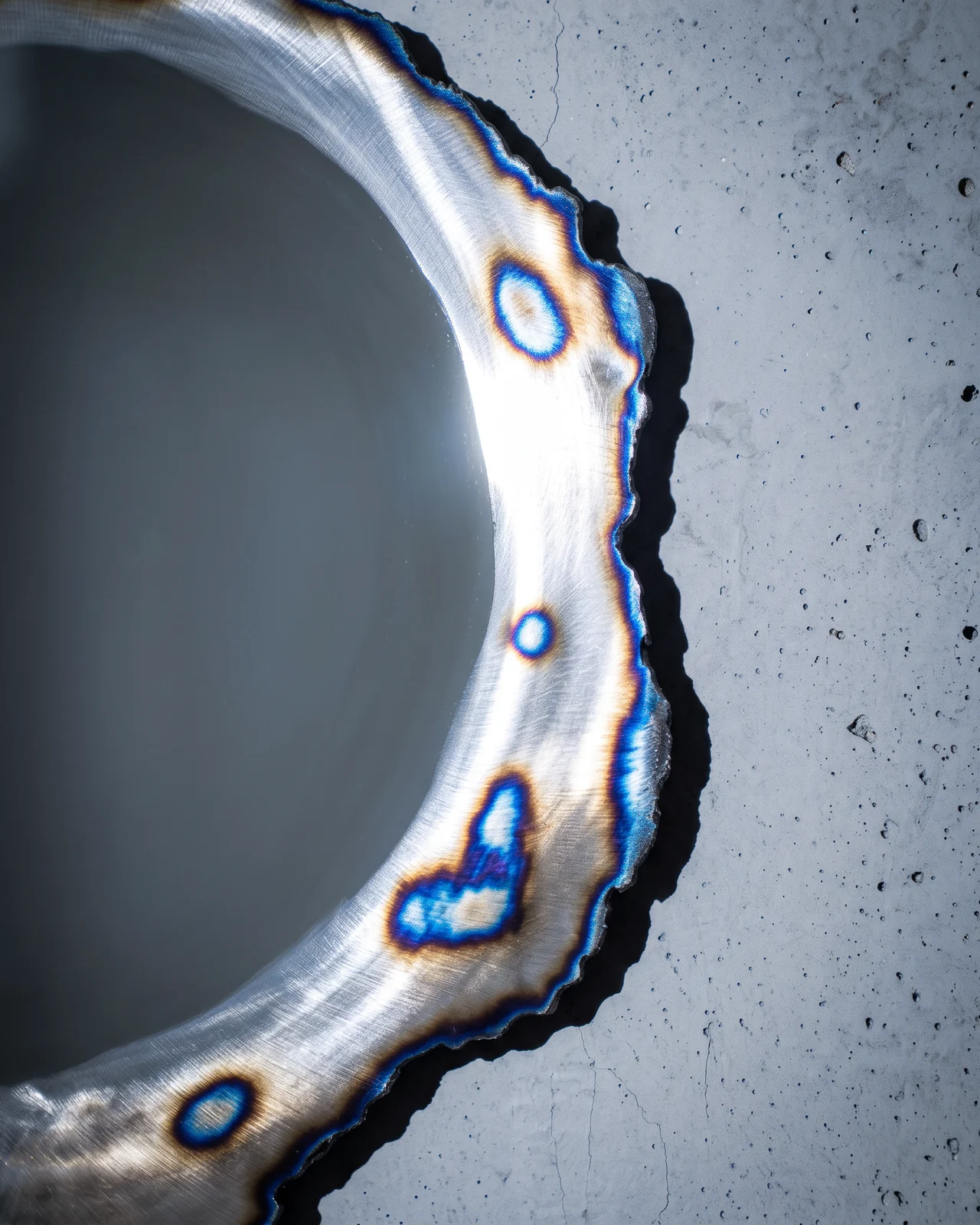 Burned edge of the Ustio Mirror, heat-tinted steel, by Paul Hardy